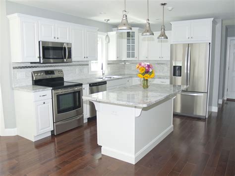 kitchen with white cabinets and stainless steel appliances|white countertops with white appliances.